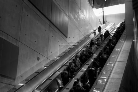 Photo for People being transported by the escalator at the Helsinki Airport in Finland. - Royalty Free Image