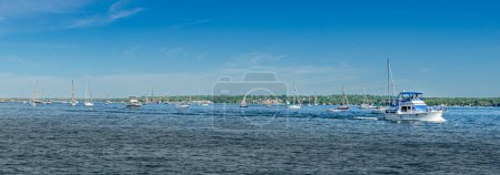 Yachts, boats, sailboats, and ships on a sailing parade on the St. Lawrence River in Brockville, Ontario,  Canada