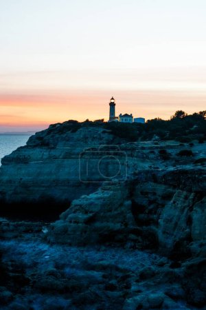The wild and scenic limestone coast of the Algarve, Portugal, with the Alfanzina Lighthouse. Between Benagil and Alfanzina.