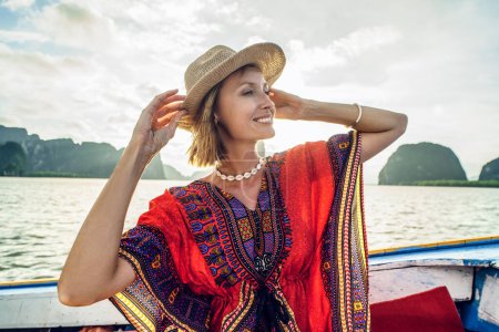 Téléchargez les photos : Travel tour by traditional long tail boat on tropical islands in Thailand. Woman sitting, smiling and relaxing, looking at the landscape. Summer exotic holidays in Asia - en image libre de droit