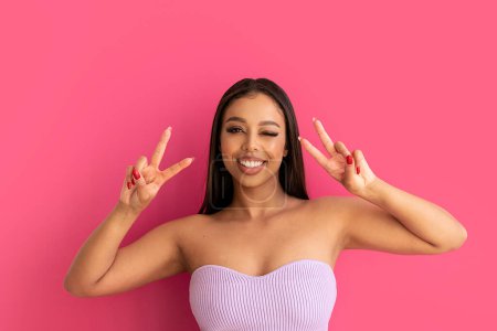 Photo for Happy woman smiling, looking at the camera, posing on a pastel pink Studio Background. Real people emotions, toothy smile. Fashionable young girl, A lot of copy space. - Royalty Free Image