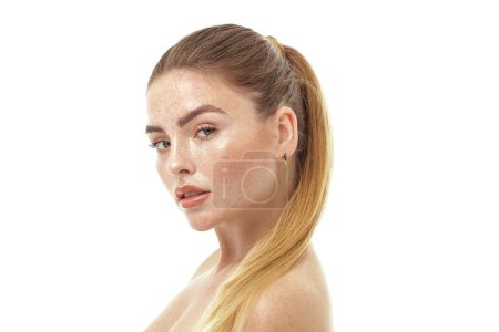 Photo for Beauty portrait of real natural woman with freckles on her face and shoulders. Girl looking at the camera. White studio background. Skin care concept. Ideal, delicate makeup - Royalty Free Image