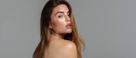 Photo for Studio beauty portrait of very natural woman with freckles on her face and shoulder. Girl looking at the camera. A lot of copy space. Skin care concept. Ideal, delicate makeup - Royalty Free Image