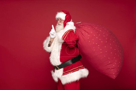 Photo for Christmas are coming! Real Santa Claus carrying big red sack. - Royalty Free Image