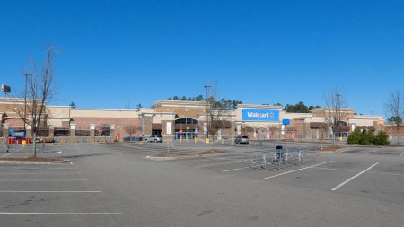 Photo for Grovetown, Ga USA - 12 25 22: Walmart grocery store exterior clear blue sky empty parking lot - Royalty Free Image