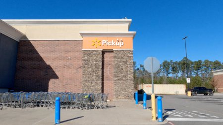 Photo for Grovetown, Ga USA - 12 25 22: Walmart supercenter exterior clear blue sky pick up orange sign - Royalty Free Image
