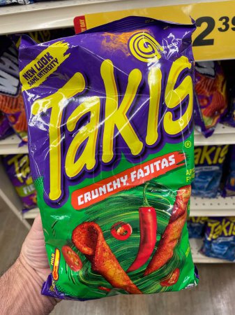 Photo for Grovetown, Ga USA - 01 13 23: Grocery store Hand holding Taki chips crunchy fajitas - Royalty Free Image