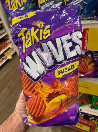 Photo for Grovetown, Ga USA - 01 13 23: Grocery store Hand holding Taki chips fuego - Royalty Free Image