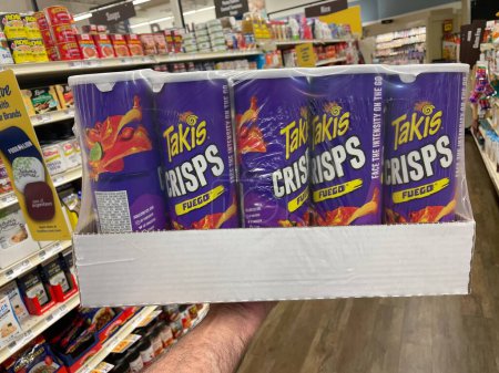 Photo for Grovetown, Ga USA - 03 10 23: Grocery store Takis crisps canister hand holding case - Royalty Free Image