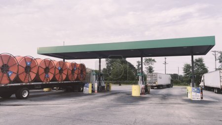 Photo for Augusta, Ga USA - 06 17 23: AM PM Truck stop and convenience store distant semi trucks - Royalty Free Image