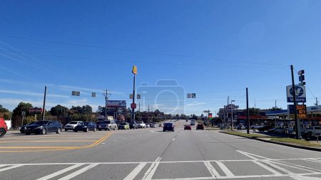 Photo for Augusta, Ga USA - 11 14 22: POV Driving clear blue sky and traffic on Belair road - Royalty Free Image
