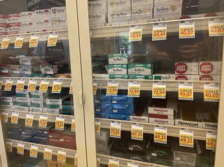 Photo for Grovetown, Ga USA - 05 10 22: Food Lion grocery store cigarette case and prices side view - Royalty Free Image
