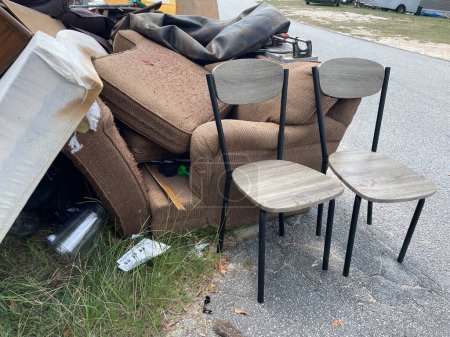 Photo for Grovetown, Ga USA - 09 08 23: Furniture piled up from eviction on curb chairs - Royalty Free Image