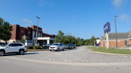 Photo for Statesboro, Ga USA - 08 09 23: cars waiting to turn Springhill suites hotel clear blue sky - Royalty Free Image
