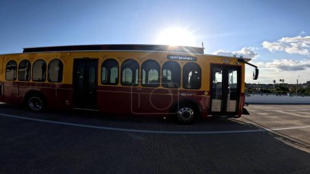 Photo for Treasure Island, Fla USA - 08 09 23: Treasure Island Orange and yellow trolley bus side - Royalty Free Image