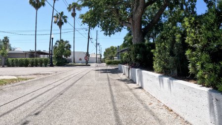 Téléchargez les photos : Lakeland, Fla États-Unis - 04 17 24 : Route arrière étroite Mur en stuc blanc - en image libre de droit