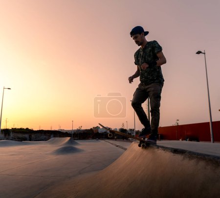 Photo for Young man skates in a skate park at sunset y Gran Canaria. Canary Islands - Royalty Free Image