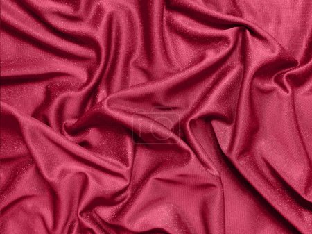 Viva magenta shiny crumpled fabric background. Color of the year 2023  