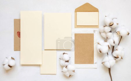 Photo for Blank cards and envelope with cotton flowers top view on white, mockup. Romantic scene with wedding suite. Bohemian pastel greeting or wedding set - Royalty Free Image