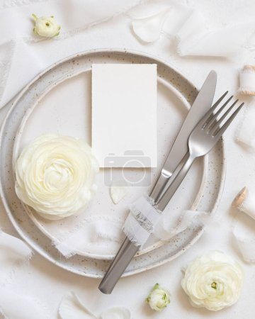 Photo for Wedding table setting with small card near cream roses and white silk ribbons top view,  mockup. Romantic scene with vertical table place card and pastel flowers. Valentines, Spring or Mothers day concept - Royalty Free Image