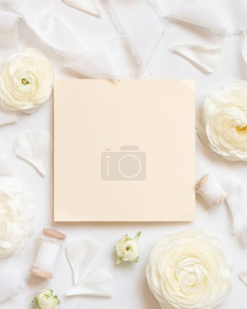 Photo for Blank card near cream roses and white silk ribbons top view, wedding mockup. Romantic scene with Square card and pastel flowers flat lay. Valentines, Spring or Mothers day concept - Royalty Free Image