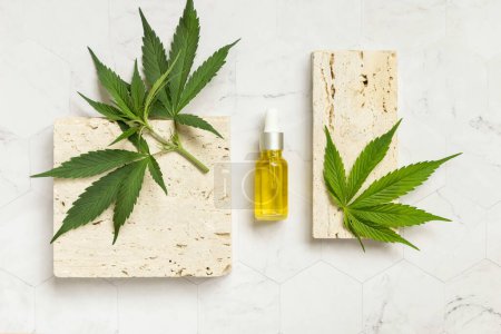 Photo for Dropper bottle with pipette near beige stone and green cannabis leaves top view on marble. Organic Eco friendly CBD oil. Alternative healthcare product for sleep and rela - Royalty Free Image