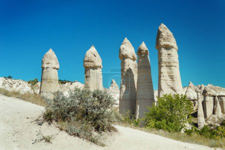 Photo for Unique geological formations in Love Valley in Cappadocia against blue sky in summer. Popular touristic area in Goreme, Nevsehir, Turke - Royalty Free Image