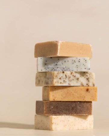 Photo for Tower stack of beige handmade soap bars on light beige close up. Natural hygiene products for body and skin care, minimal pastel composition - Royalty Free Image