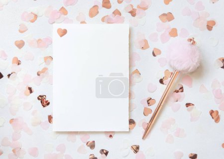 Photo for Horizontal card and envelope between pink hearts and fur pen on white table top view. Romantic mockup for Wedding, Valentines, Spring or Mothers day - Royalty Free Image
