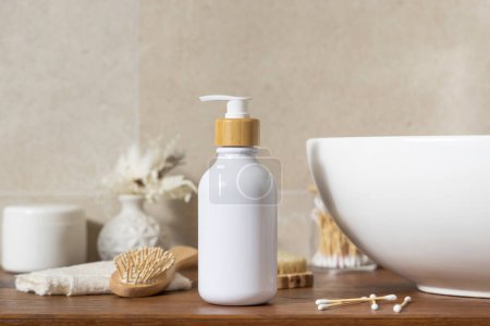 Photo for Cosmetic one pump bottle near basin, beauty and personal care products on wooden countertop against beige wall in bathroom close up, sustainable cosmetic packaging mockup - Royalty Free Image
