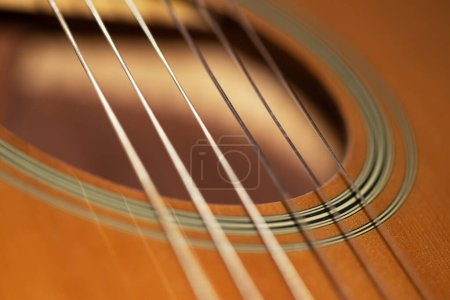 Acoustic classical guitar with strings, top deck, sound hole, close-up view, macro