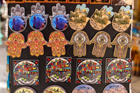 Photo for Jerusalem, Israel February 25,2023 Close up of beautiful decorative magnets with hamza against the evil eye and Armenian tile of Jerusalem souvenirs sold in the old city in Jerusalem, Israel - Royalty Free Image