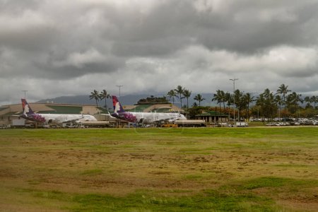 Photo for Lihue, Kauai, Hawaii June 14, 2023 Lihue airport with two Hawaii airline planes next to the terminal. - Royalty Free Image