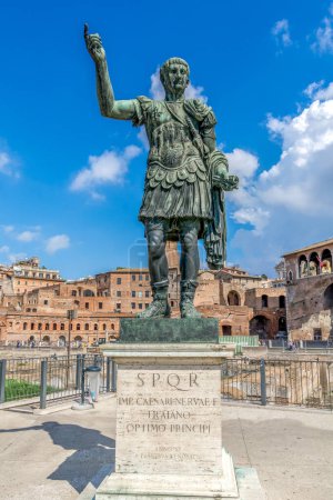 Photo for Rome, Italy 10-03-2016 Statue of Julius Caesar againts a blue sky with white clouds and the ancient forum in the background in Rome, Italy. - Royalty Free Image