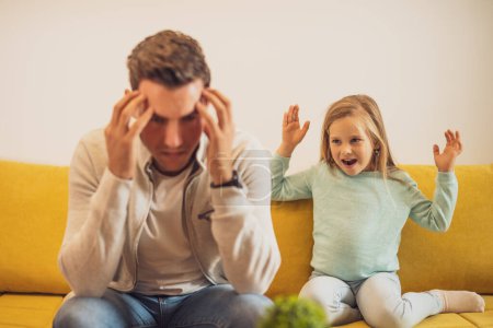 Photo for Daughter is screaming at her stressed father at their home. - Royalty Free Image