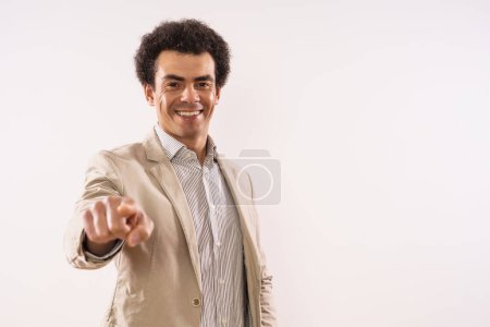 Foto de Portrait of happy businessman pointing. - Imagen libre de derechos
