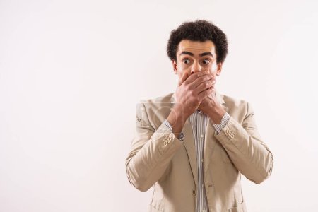 Photo for Portrait of a shocked  businessman  covering his mouth. - Royalty Free Image