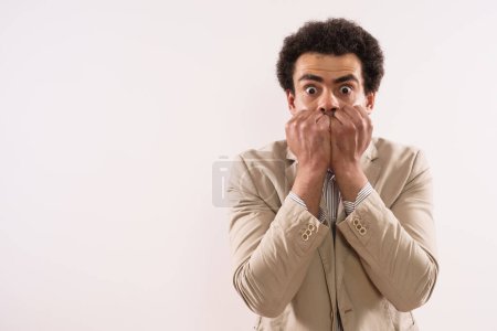 Foto de Portrait of a shocked  businessman  covering his mouth. - Imagen libre de derechos