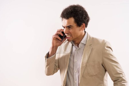 Téléchargez les photos : Image of angry businessman talking on the phone. - en image libre de droit