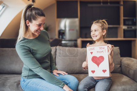 Téléchargez les photos : Happy mother and  daughter with  heart shapes and text on greeting card.  Mother's day concept. - en image libre de droit