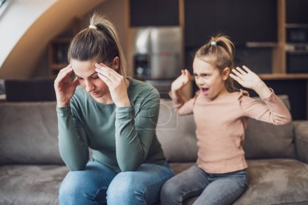 Photo for Stressed mother is  feeling desperate because of  screaming  her daughter. - Royalty Free Image