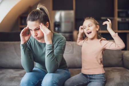 Photo for Stressed mother is  feeling desperate because of  screaming  her daughter. - Royalty Free Image