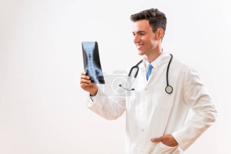 Téléchargez les photos : Image d'un jeune médecin tenant une radiographie. - en image libre de droit