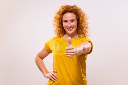 Photo for Beautiful and happy ginger woman showing thumb up. - Royalty Free Image