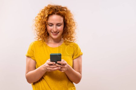 Photo for Image of happy ginger woman using phone. - Royalty Free Image