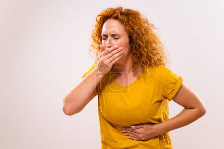 Photo for Ginger woman doesn't feel good and she is going to vomit. - Royalty Free Image