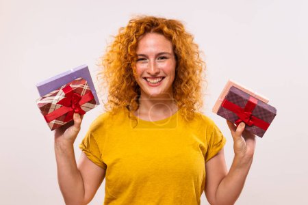 Photo for Image of beautiful happy ginger woman holding gift boxes. - Royalty Free Image