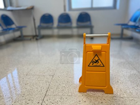 Photo for Slippery sign on wet floor in office building - Royalty Free Image