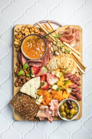 Antipasto meat board. catering platter with jamon, sausage and cheese. Food recipe background. Close up.