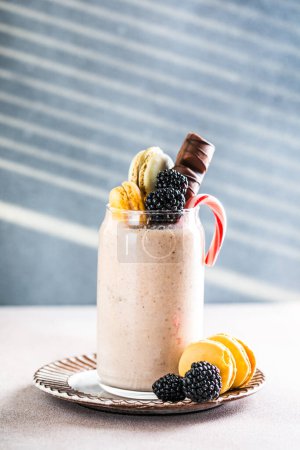 Photo for Chocolate indulgent frosting exreme milkshake with donut and sweets. Crazy freakshake food trend. Copy space - Royalty Free Image